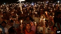 FILE - Pakistani Christians hold candles during a vigil for victims of a deadly suicide bombing on March 27 in Lahore, Pakistan, March 30, 2016. 