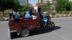 Afghan women and children travel in a motorcycle cart during fighting between Taliban and Afghan security forces in Herat province, west of Kabul, Afghanistan, Sunday, Aug. 1, 2021. (AP Photo/Hamed Sarfarazi)