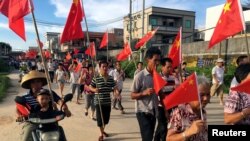 Villagers carrying Chinese national flags protest at Wukan village in China's Guangdong province, June 20, 2016. 