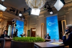 President Joe Biden, center, Secretary of State Antony Blinken, left, and Special Presidential Envoy for Climate John Kerry, right, listen during the virtual Leaders Summit on Climate.