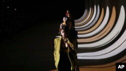 FILE - In this Feb. 25, 2020 file photo, model Kaia Gerber leads other models as they wear creations for the Saint Laurent fashion collection during Women's fashion week Fall/Winter 2020/21 presented in Paris. The coronavirus pandemic has instilled extra 