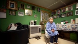 In this Monday, Jan. 20, 2020 image, Lizzie Chimiugak, right, looks on at her home in Toksook Bay, Alaska. Chimiugak, who turned 90 years old on Monday, is scheduled to be the first person counted in the 2020 U.S. Census on Tuesday.