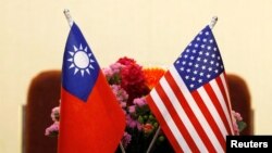 FILE - Flags of Taiwan and the United States are displayed ahead of a meeting between U.S. and Taiwan legislators in Taipei, March 27, 2018.