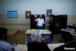 FILE - Election officials count votes at a polling station during a referendum in Izmir, Turkey, April 16, 2017.
