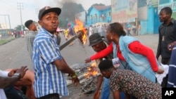 Protesters construct a burning roadblock in Kinshasa, Congo, Monday Jan. 21, 2019. Congo’s police dispersed a gathering Monday of supporters waiting to hear a speech by presidential runner-up Martin Fayulu, his spokeswoman said.