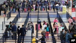 Passengers check-in at the Jorge Chavez International Airport in Callao, Peru, Oct. 5, 2020.