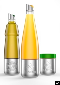 This photo shows Lesieur's stainless steel vegetable oils and mayonnaise containers designed for use with Loop. (Team Créatif/Lesieur/TerraCycle via AP)