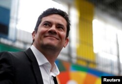 FILE - Brazilian federal judge Sergio Moro waits to cast his vote in Curitiba, Brazil, Oct. 7, 2018.