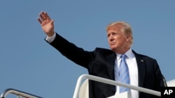 President Donald Trump waves as he boards Air Force One at Andrews Air Force Base, Maryland, July 3, 2018.