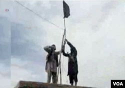 IS Khorasan group mounts a flag in tribal region of Afghanistan, Nov. 2, 2015.