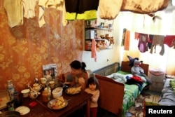 Residents who lost their home sit in a dorm room where they have lived for the past three years, in Donetsk, Ukraine, Sept. 28, 2017.