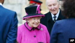 Britain's Queen Elizabeth II meets recipients of Motability vehicles as she arrives in the Quadrangle for a ceremony at Windsor Castle.