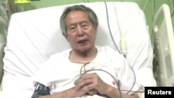 Peru's former President Alberto Fujimori asks for forgiveness from Peruvians as he lies in hospital bed in Lima, Peru, in this still image taken from a video posted on Facebook on Dec. 26, 2017.
