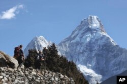 FILE - Trekkers make their way to Dingboche, a popular Mount Everest base camp.