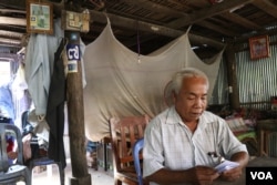 Chan Leap, 66, a district official for the opposition Cambodian National Rescue Party until it was dissolved in mid-November, sits at his house in Takeo province. He said he did not defect to the ruling Cambodian People’s Party, but urged others to do so. (Sun Narin/VOA Khmer)