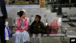 A Yemeni girl and boy wait in the departure lounge at Sana'a International airport, in Yemen, Feb. 3, 2020. A United Nations medical relief flight carrying patients from Yemen's rebel-held capital took off Monday.