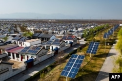 FILE - An aerial view shows residential buildings with roof-mounted photovoltaic solar panels in Yinchuan, in northwestern China's Ningxia region on March 31, 2024. (Photo by AFP)