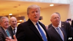 FILE - U.S. President Donald Trump talks to journalists as he arrives during the annual meeting of the World Economic Forum in Davos, Switzerland, Jan. 25, 2018. 