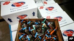 In this Thursday, Dec. 10, 2015, photo, live lobsters are packed for overseas shipment at the Maine Lobster Outlet in York, Maine. (AP Photo/Robert F. Bukaty)