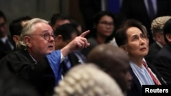 FILE - An attorney defending Myanmar against genocide charges at the UN's International Court of Justice and Myanmar's leader Aung San Suu Kyi attend a hearing on the second day of hearings in a case against Myanmar alleging genocide against the minority Muslim Rohingya population, at the ICJ in The Hague, Netherlands December 11, 2019.