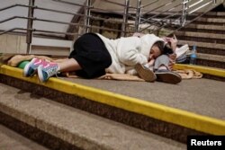 People take shelter inside a metro station during an overnight Russian missile attack in Kyiv