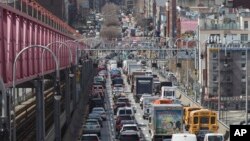 In this March 28, 2019 photo, traffic makes its way into Manhattan from Brooklyn over the Williamsburg Bridge in New York. A congestion toll that would charge drivers to enter New York City's central business district is a first for an American city. Sta