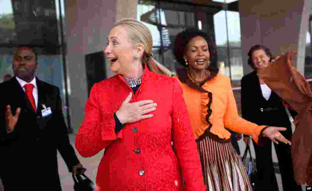 Hillary Clinton and South Africa's Foreign Minister Maite Nkoana-Mashabane see a rare snow flurry as they leave business meetings in Pretoria, South Africa, August 7, 2012.