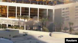 Smoke rises after a Tesla Cybertruck burned at the entrance of Trump Tower in Las Vegas, Nevada, U.S., January 1, 2025, in this screengrab from a video obtained from social media. (Jeffrey Miller/via Reuters)