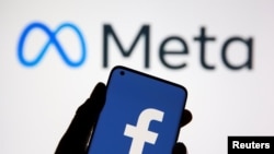 FILE - A smartphone with Facebook's logo is seen in front of the Meta logo in this illustration taken Oct. 28, 2021. 