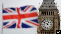 FILE - British Union flag waves in front of the Elizabeth Tower at Houses of Parliament containing the bell know as Big Ben in central London, March 29, 2017. 