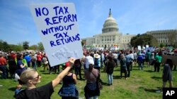 Protesters gather on Capitol Hill in Washington during a Tax Day demonstration calling on President Donald Trump to release his tax returns, April 15, 2017. 