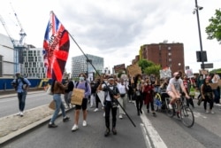 FILE - People take to the streets to march in London, July 11, 2020, in the wake of the killing of George Floyd by a police officer in Minneapolis.