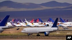 FILE - In this March 25, 2020, file photo, passenger and cargo aircraft are seen stored at Southern California Logistics Airport, in Victorville, Calif., to the pandemic. A record drop in U.S. energy consumption this spring was driven by less demand for fuel. (AP)