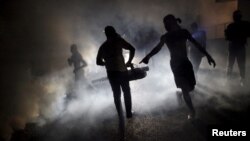 FILE - A worker of the Ministry of Public Health and Population fumigates in the street against mosquito breeding to prevent diseases such as malaria, dengue and Zika in Port-au-Prince, Haiti, Feb. 15, 2016.