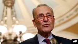 FILE - Senate Minority Leader Chuck Schumer speaks to reporters on Capitol Hill in Washington, Oct. 22, 2019. Schumer is proposing a trade-in program to get millions of Americans out of climate-damaging gas vehicles and into electric or hybrid cars.