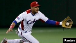 FILE - Cuba's third baseman Yulieski Gurriel catches the ball in the first inning at the World Baseball Classic (WBC) second round game in Tokyo, March 9, 2013.
