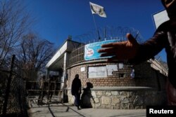 An Afghan student walks in front of the Kabul University in Kabul, Afghanistan, on December 21, 2022. (REUTERS/Ali Khara)