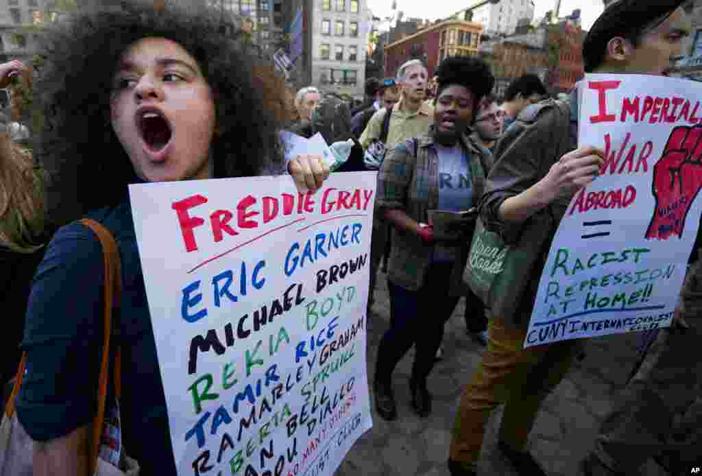 People yell out while gathered to protest the death of Freddie Gray, a Baltimore man who was mortally injured while in police custody, Union Square, in New York, April 29, 2015.
