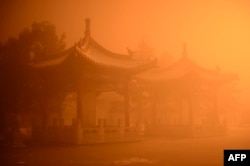 FILE - Pagodas are seen on a polluted day in Hohhot, north China's Inner Mongolia region.