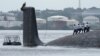 Para anggota kru bekerja di kapal selam bertenaga nuklir Rusia "Kazan" yang berlabuh di Teluk Havana, Kuba, 12 Juni 2024.