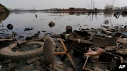 Trash litters the shore of Guanabara Bay in the Caju neighborhood of Rio de Janeiro, Brazil, Feb. 25, 2015.