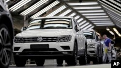 FILE - Volkswagen cars are pictured as they undergo a final quality control at the Volkswagen plant in Wolfsburg, Germany, March 8, 2018.