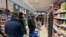 Customers line up to buy food and essential products in a Milan supermarket March 7, 2020, as Italy prepared to quarantine more than 15 million people around Milan and Venice for nearly a month to halt the spread of the new coronavirus.