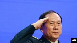 Chinese Defense Minister Gen. Wei Fenghe salutes attendees ahead of the fourth plenary session of the 18th International Institute for Strategic Studies Shangri-la Dialogue, an annual defense and security forum in Asia, in Singapore, June 2, 2019.