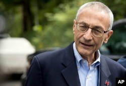FILE - Hillary Clinton campaign chairman John Podesta speaks to members of the media outside Clinton's home in Washington, Oct. 5, 2016.