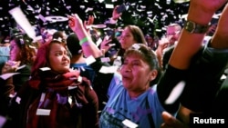 Adrian Avella and Mazeda Uddin react during the midterm election night party of Democratic congressional candidate Alexandria Ocasio-Cortez in New York City, Nov. 6, 2018. 