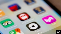 The Uber app icon is displayed on an iPhone in New York, June 26, 2017.