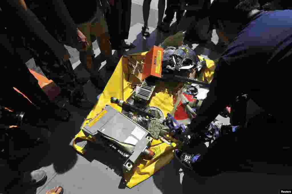 Indonesian soldiers stand near parts of AirAsia 8501 on the deck of KRI Banda Aceh, in the Java Sea, Jan. 13, 2015.