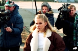 U.S. figure skating champion Tonya Harding is followed by media as she walks from an apartment in Beaverton, near Portland, Ore., to her truck on Feb. 6, 1994.