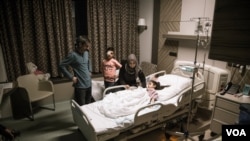 A Syrian Kurdish family lost a 13-year old boy during the Turkish incursion into Northern Syria, gathering around their 8 year old daughter who lost her leg in same incident, Northern Iraq, Sulaimaniyah.